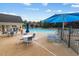 Community pool featuring lounge chairs, tables, and a covered seating area, perfect for relaxation at 417 Downing Glen Dr, Morrisville, NC 27560
