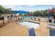 Community pool area with hot tub featuring lounge chairs, umbrellas, and a fence at 417 Downing Glen Dr, Morrisville, NC 27560