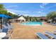 Community pool area featuring lounge chairs, tables, and a covered seating area for residents at 417 Downing Glen Dr, Morrisville, NC 27560