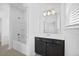 Well-lit bathroom featuring a vanity with dark cabinets and a shower-tub combo at 4508 Valley Crest Ln, Fuquay Varina, NC 27526
