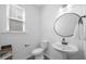 Half bathroom boasts a pedestal sink, stylish fixtures, and decor at 4508 Valley Crest Ln, Fuquay Varina, NC 27526