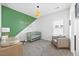 Bright Bedroom with sage and white color scheme, wooden crib, and comfortable armchair near window at 4508 Valley Crest Ln, Fuquay Varina, NC 27526