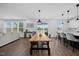 Open-concept dining area with hardwood floors, island seating, and lots of natural light at 4508 Valley Crest Ln, Fuquay Varina, NC 27526