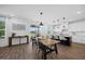 Bright dining area showcases stylish pendant lighting, breakfast bar and a long wooden table at 4508 Valley Crest Ln, Fuquay Varina, NC 27526