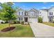 Charming two-story home with manicured lawn, gray siding, stone accents, and a two-car garage at 4508 Valley Crest Ln, Fuquay Varina, NC 27526