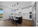 Bright kitchen features a central island with seating, white cabinets, and modern appliances at 4508 Valley Crest Ln, Fuquay Varina, NC 27526