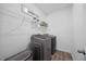 Well-equipped laundry room with modern washer and dryer, shelving, and ample storage at 4508 Valley Crest Ln, Fuquay Varina, NC 27526