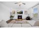 Cozy living room showcases a fireplace, hardwood floors, ceiling fan, and lots of natural light at 4508 Valley Crest Ln, Fuquay Varina, NC 27526