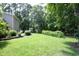 The backyard showcases a sprawling lawn, neatly trimmed shrubs, and a storage shed, offering both beauty and functionality at 4601 Basilica Dr, Holly Springs, NC 27540