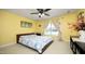 Bright bedroom with yellow walls, a comfortable bed, and a window with patterned curtains at 4601 Basilica Dr, Holly Springs, NC 27540
