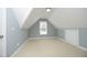 Bright bonus room with blue walls, a window, and neutral carpeting offering a versatile space at 4601 Basilica Dr, Holly Springs, NC 27540