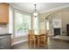 Bright breakfast nook with a view of the backyard and a dining table for casual meals at 4601 Basilica Dr, Holly Springs, NC 27540
