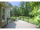 Outdoor deck with railing overlooks a lush backyard with mature trees and greenery at 4601 Basilica Dr, Holly Springs, NC 27540
