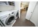 Laundry room with front-load washer and dryer and view into the kitchen at 4601 Basilica Dr, Holly Springs, NC 27540