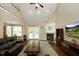 Cozy living room with a fireplace, hardwood floors, and view of the dining area at 4601 Basilica Dr, Holly Springs, NC 27540