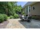Outdoor patio with stone pavers, a dining table set, and backyard landscaping at 4601 Basilica Dr, Holly Springs, NC 27540
