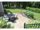 Outdoor patio area with stone pavers, a dining table, and lush landscaping at 4601 Basilica Dr, Holly Springs, NC 27540