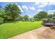 Lush backyard features a spacious lawn, shed, and pergola-covered patio at 5 Windsor Pl, Mebane, NC 27302