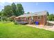 Brick home with a black deck and grassy backyard for outdoor enjoyment at 5 Windsor Pl, Mebane, NC 27302
