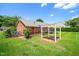 Private backyard boasts a pergola, brick patio, and lush lawn for outdoor relaxation at 5 Windsor Pl, Mebane, NC 27302