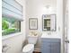 Stylish bathroom with updated fixtures, vanity, and framed artwork with natural light at 5 Windsor Pl, Mebane, NC 27302