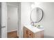 Bright bathroom with wooden vanity, stylish mirror, and tile flooring at 5 Windsor Pl, Mebane, NC 27302