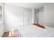 Bedroom with neutral colored walls, window, closet, and wood-look flooring at 5 Windsor Pl, Mebane, NC 27302