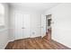 Bedroom features neutral walls, wood-look flooring, and closet storage space at 5 Windsor Pl, Mebane, NC 27302