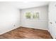 Bedroom with neutral walls, wood look floors, and bright natural light at 5 Windsor Pl, Mebane, NC 27302