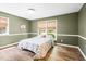 Comfortable bedroom with updated floors, fresh paint, and natural light from two windows at 5 Windsor Pl, Mebane, NC 27302