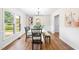 Elegant dining room with a stylish table set, modern lighting, and large windows providing lots of natural light at 5 Windsor Pl, Mebane, NC 27302