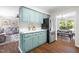 Bright kitchen showcasing painted cabinetry, stainless steel appliances, and an adjacent dining area for Gathering meals at 5 Windsor Pl, Mebane, NC 27302