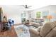 Comfortable living room featuring plush sofas, a ceiling fan, and plenty of space for entertaining or relaxing at 5 Windsor Pl, Mebane, NC 27302