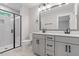 Modern bathroom featuring a double vanity, a large mirror with lighting, and a glass enclosed shower at 509 Sherron Road # 9, Durham, NC 27703