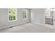 Spacious bedroom featuring plush carpet and bright windows at 509 Sherron Road # 9, Durham, NC 27703