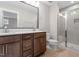 Bathroom showcasing double sink vanity, large mirror, and a glass-enclosed shower with tile surround at 509 Sherron Road Dr # 10, Durham, NC 27703