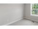 This is a bedroom with neutral walls, carpet, and a window looking out to a yard at 509 Sherron Road Dr # 10, Durham, NC 27703