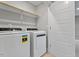 Convenient laundry room featuring modern washer, dryer, and shelving for all laundry needs at 509 Sherron Road Dr # 10, Durham, NC 27703