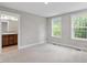 Spacious main bedroom features neutral carpet, bathroom access, and sunny backyard views at 509 Sherron Road Dr # 10, Durham, NC 27703