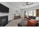 Comfortable living room with a fireplace, TV, ceiling fan, and large sectional sofa at 5332 Seaspray Ln, Raleigh, NC 27610