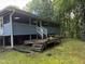 Expansive screened-in back porch with a wooden deck and steps leading to the yard at 535 Hillcrest Dr, Garner, NC 27529
