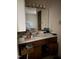 Bathroom vanity featuring cabinets, sink, mirror, and two electrical outlets at 535 Hillcrest Dr, Garner, NC 27529