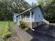 Side view of the house featuring a covered front porch and landscaping at 535 Hillcrest Dr, Garner, NC 27529