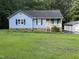 Charming single-Gathering home with light blue siding, dark shutters, and a manicured lawn at 535 Hillcrest Dr, Garner, NC 27529