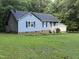 A blue house with blue shutters is surrounded by a large lawn, perfect for outdoor activities at 535 Hillcrest Dr, Garner, NC 27529
