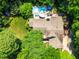 Aerial view of a home with a backyard swimming pool and lush surrounding greenery at 7401 Heartland Dr, Wake Forest, NC 27587