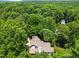 Aerial view of a home with a backdrop of green trees and natural landscape at 7401 Heartland Dr, Wake Forest, NC 27587