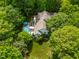 Aerial view of home featuring mature trees and a backyard with pool perfect for relaxation and outdoor enjoyment at 7401 Heartland Dr, Wake Forest, NC 27587
