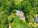 Overhead view of home with a pool, deck, and lush trees surrounding the property at 7401 Heartland Dr, Wake Forest, NC 27587