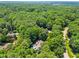 Aerial view of a house surrounded by lush trees; a verdant setting for comfortable living at 7401 Heartland Dr, Wake Forest, NC 27587